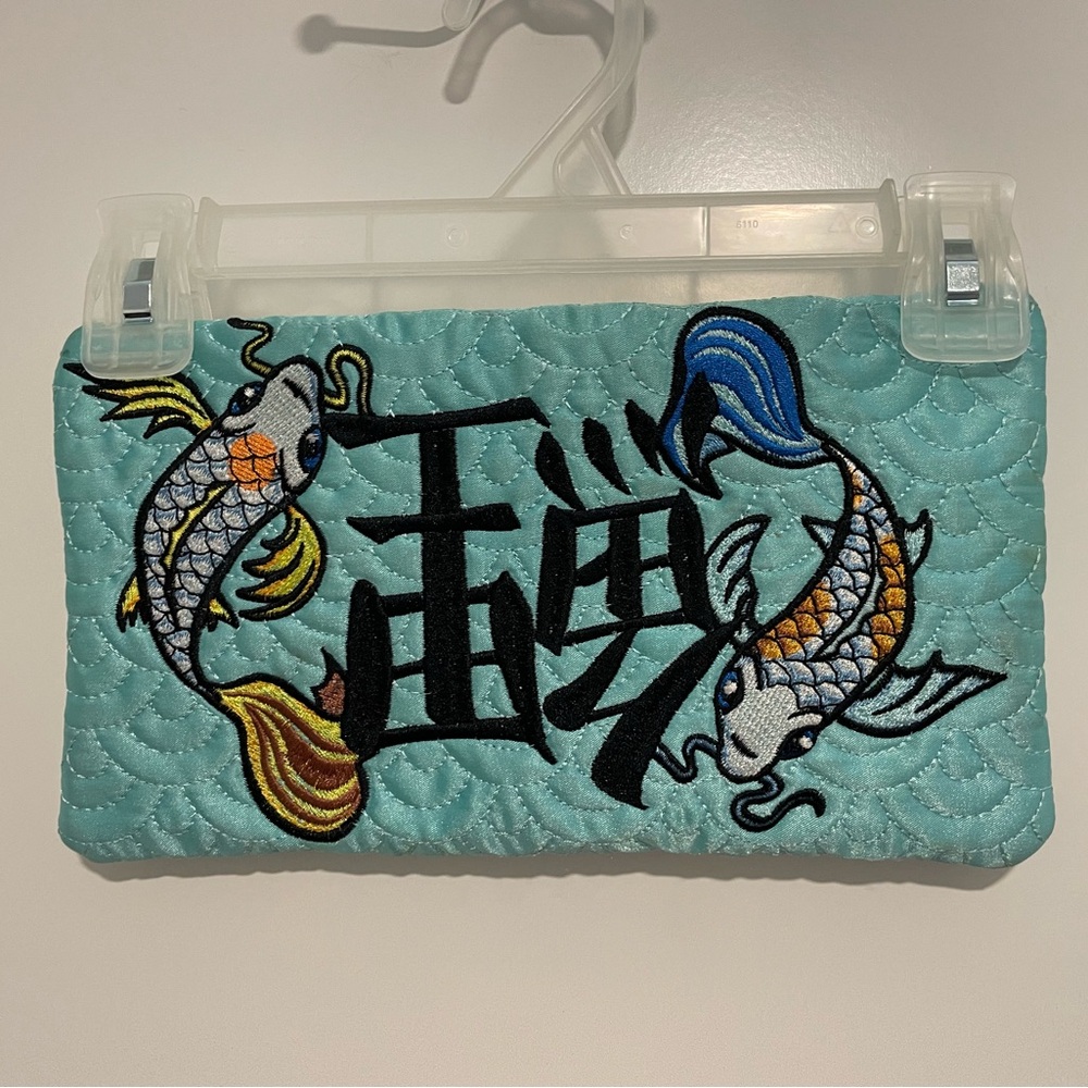 A Vintage Ed Hardy Blue and Black Clutch with Koi Design